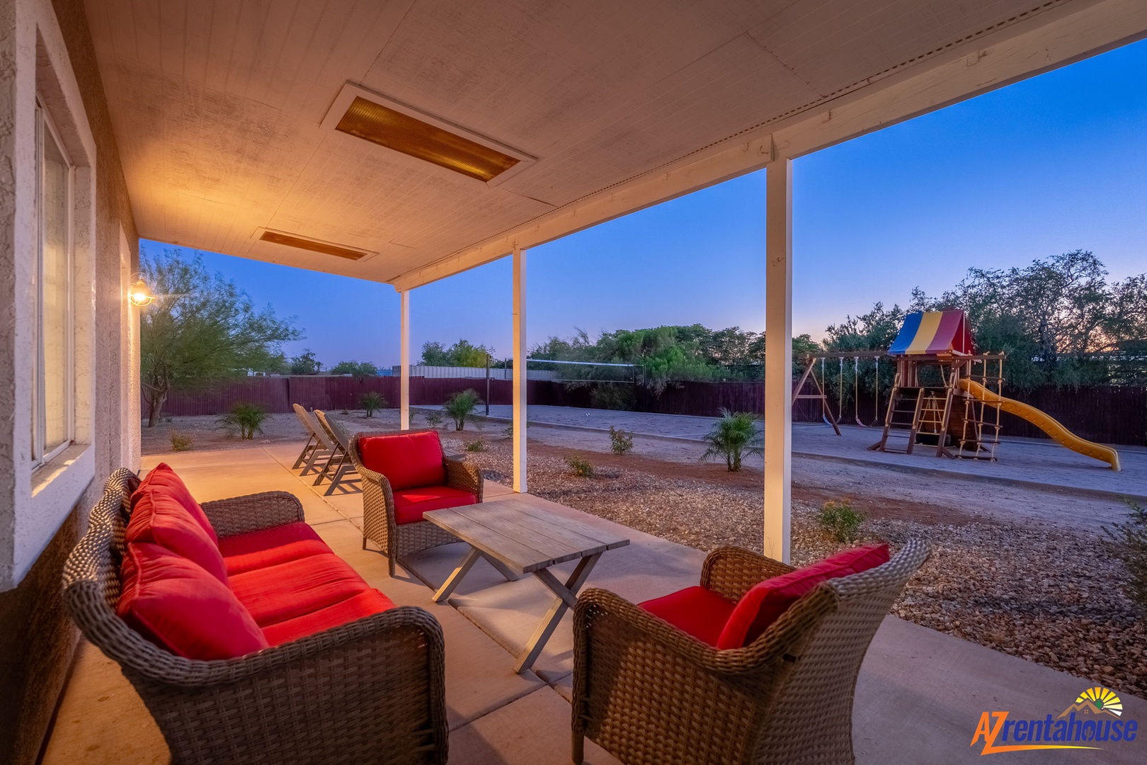 Unwind on your covered patio with comfortable seating as the kids enjoy the playground—perfect for evening relaxation and family fun.