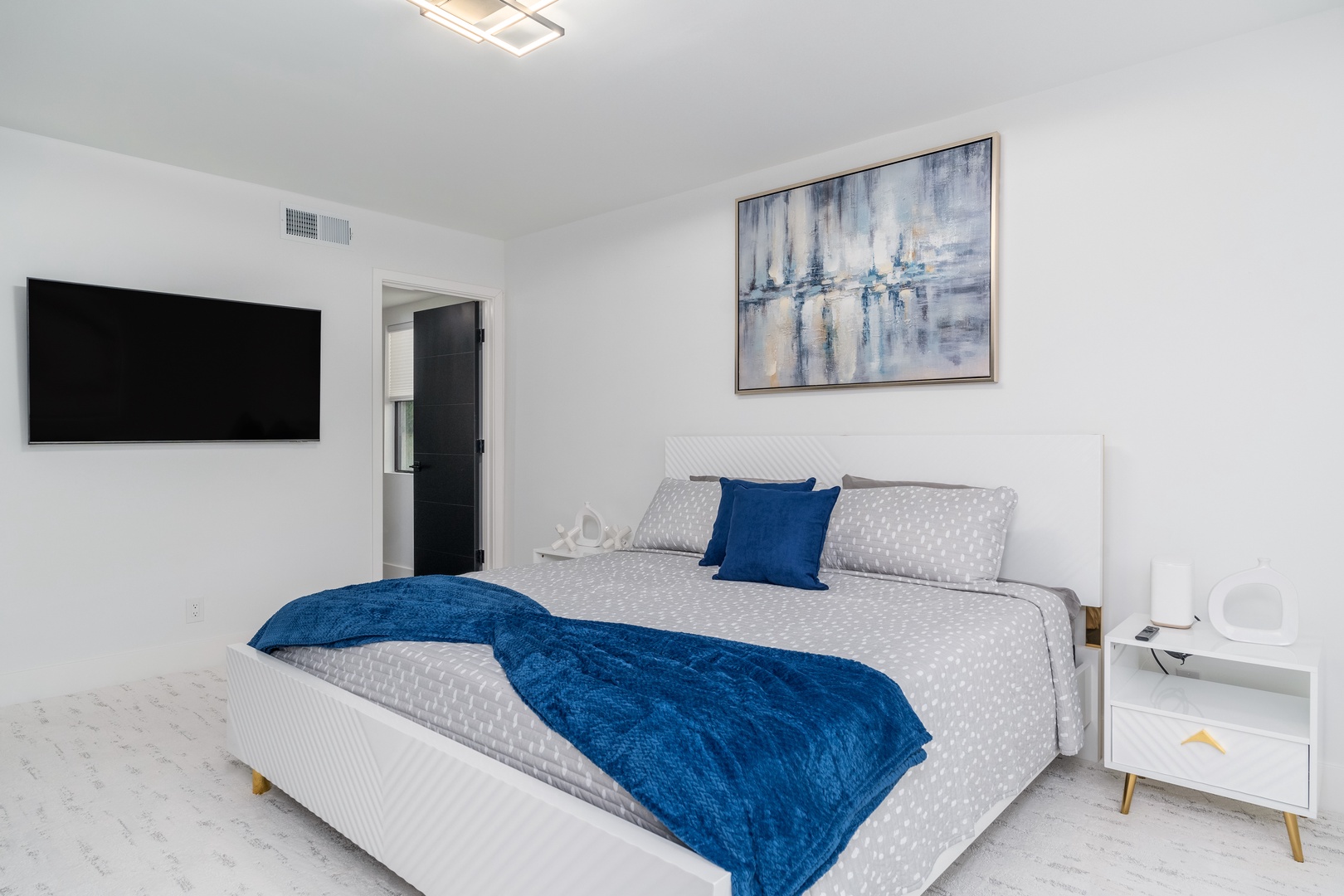 Sink into plush comfort in your private bedroom—crisp linens, calming coastal tones, and a smart TV await your arrival.