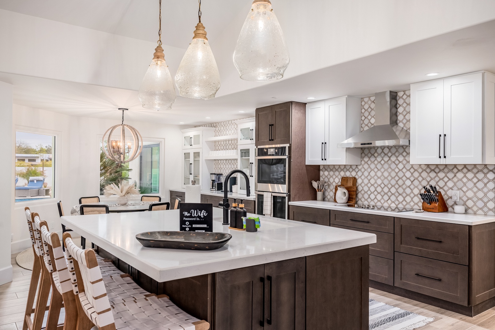 Step into your dream kitchen with gleaming white countertops, stunning pendant lighting, and custom two-tone cabinetry. With modern appliances and an open layout flowing to the dining space, you'll love every moment spent here.