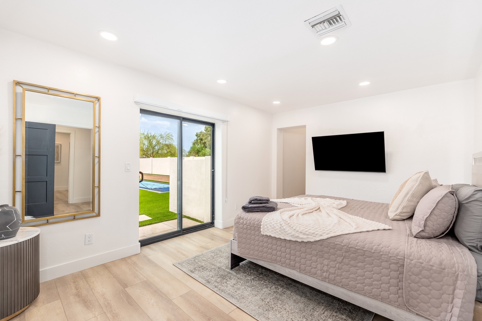 Your private bedroom opens to a sunny backyard oasis, with a flat-screen for unwinding and soft linens awaiting your arrival.