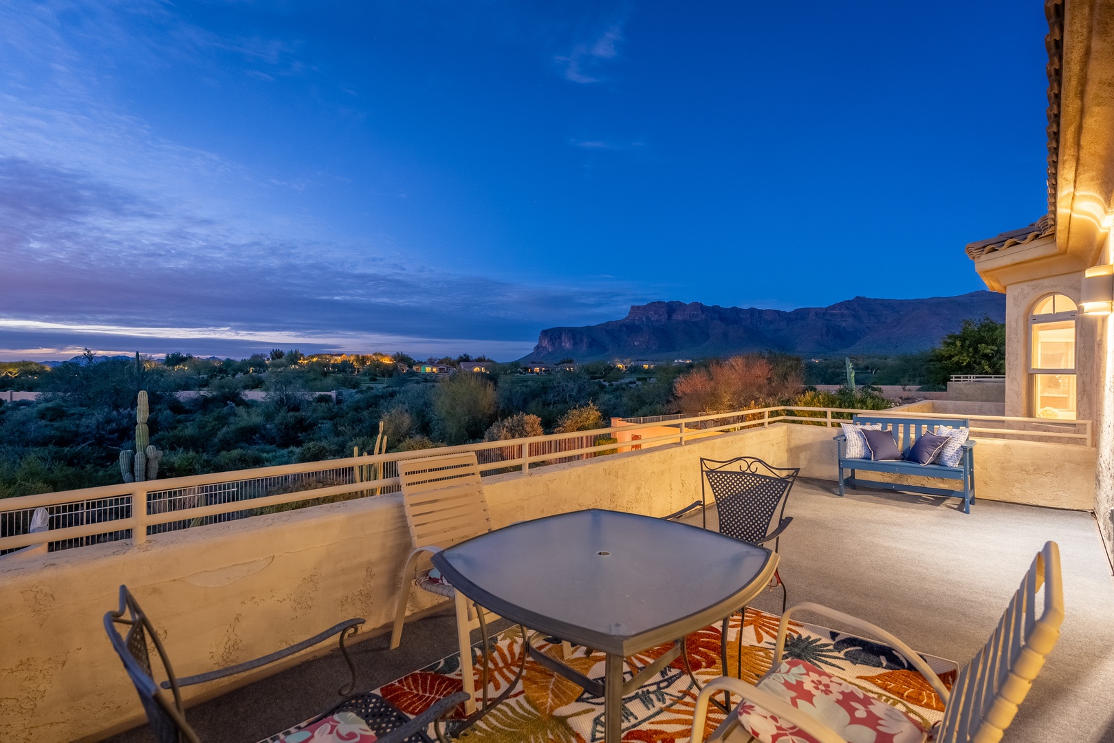 Spacious rooftop terrace offering sweeping mountain and desert vistas at twilight, perfect for outdoor dining and relaxation under Arizona skies.