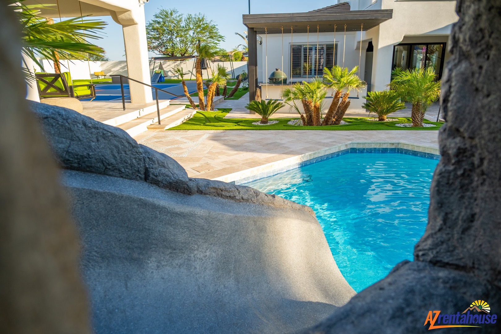 Dive into your private oasis where crystal-clear waters meet tropical palms and modern comfort in this stunning backyard retreat.