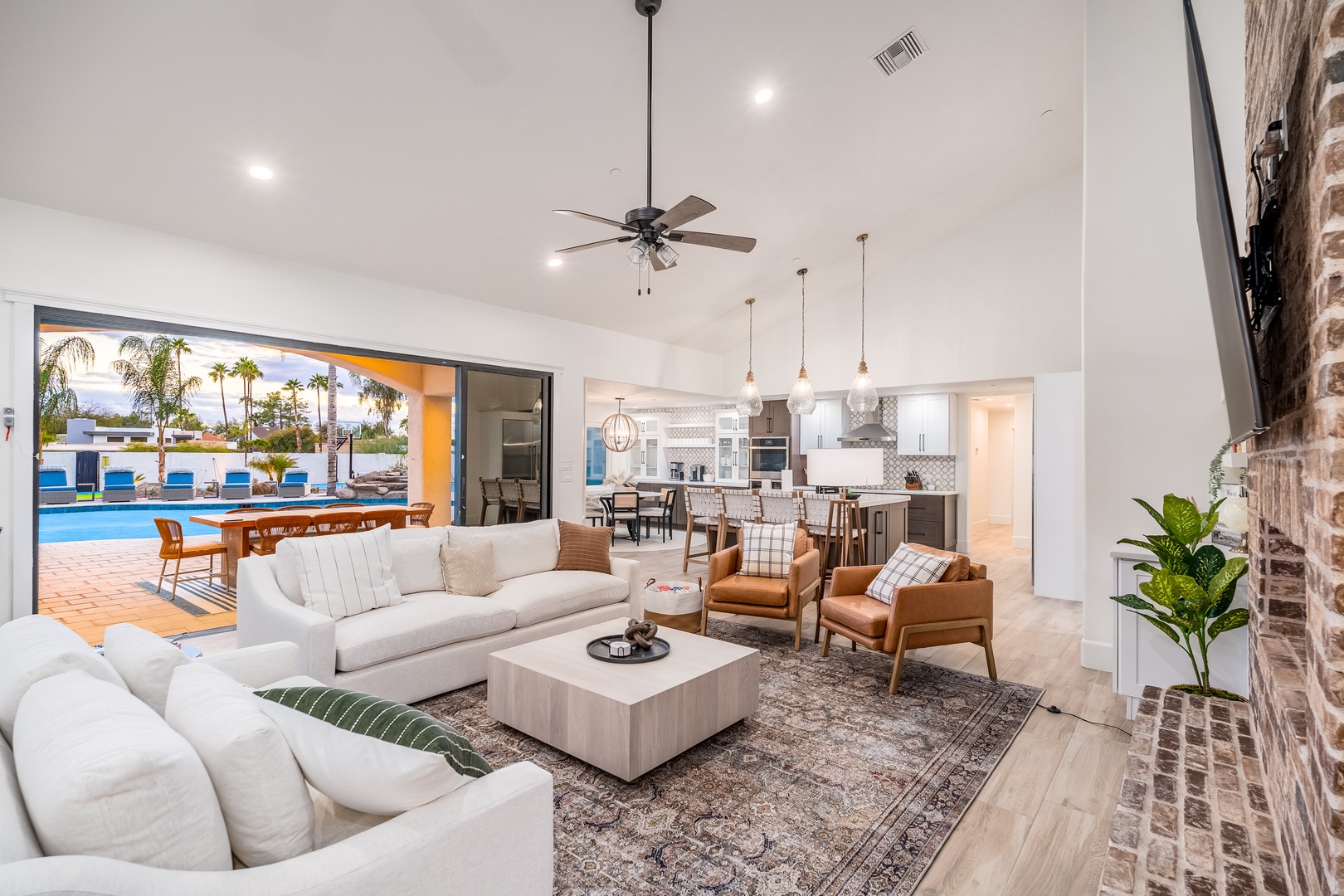 Step into an open-concept oasis where modern comfort meets resort-style living. Your spacious living area flows seamlessly to a sun-drenched pool, inviting relaxation inside and out.