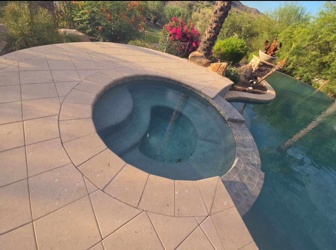 Unwind in your private hot tub overlooking lush desert landscaping and mountains. Let warm bubbles melt your stress away in this serene outdoor escape.