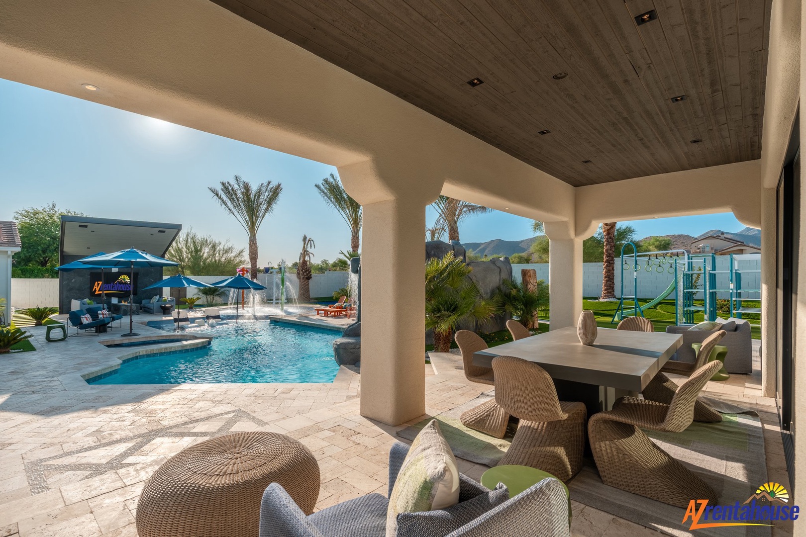 Your covered patio offers comfortable seating and dining while overlooking the sparkling pool and mountain views.