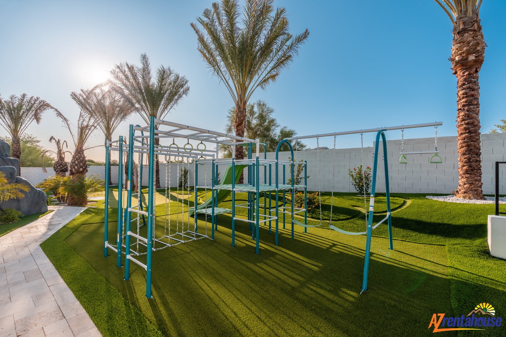 Modern fitness equipment surrounded by palm trees and lush green lawn creates an inspiring outdoor workout space.