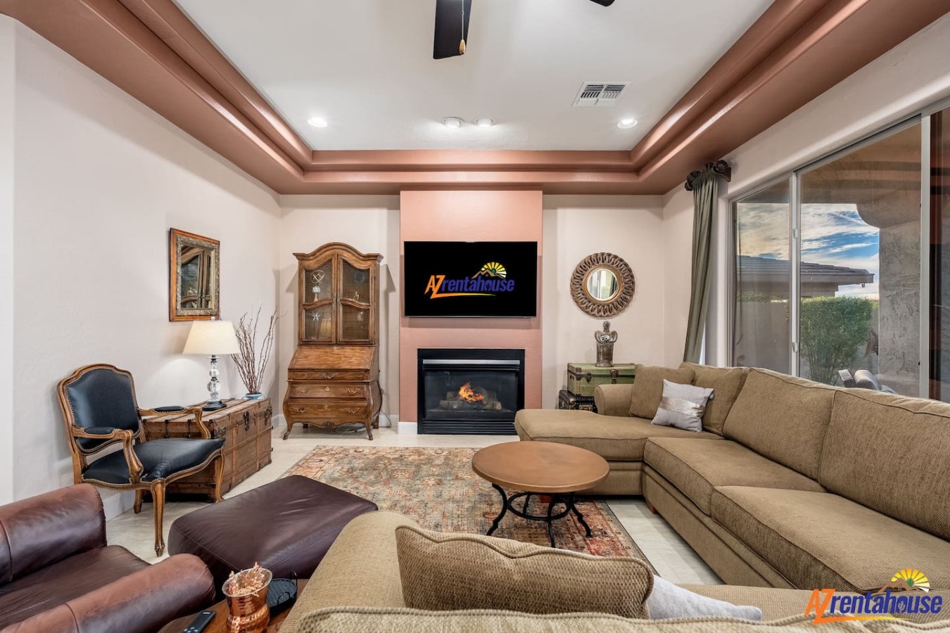 Unwind in this elegant living room with its cozy fireplace, plush sectional sofa, and warm ambient lighting creating the perfect atmosphere for relaxation.