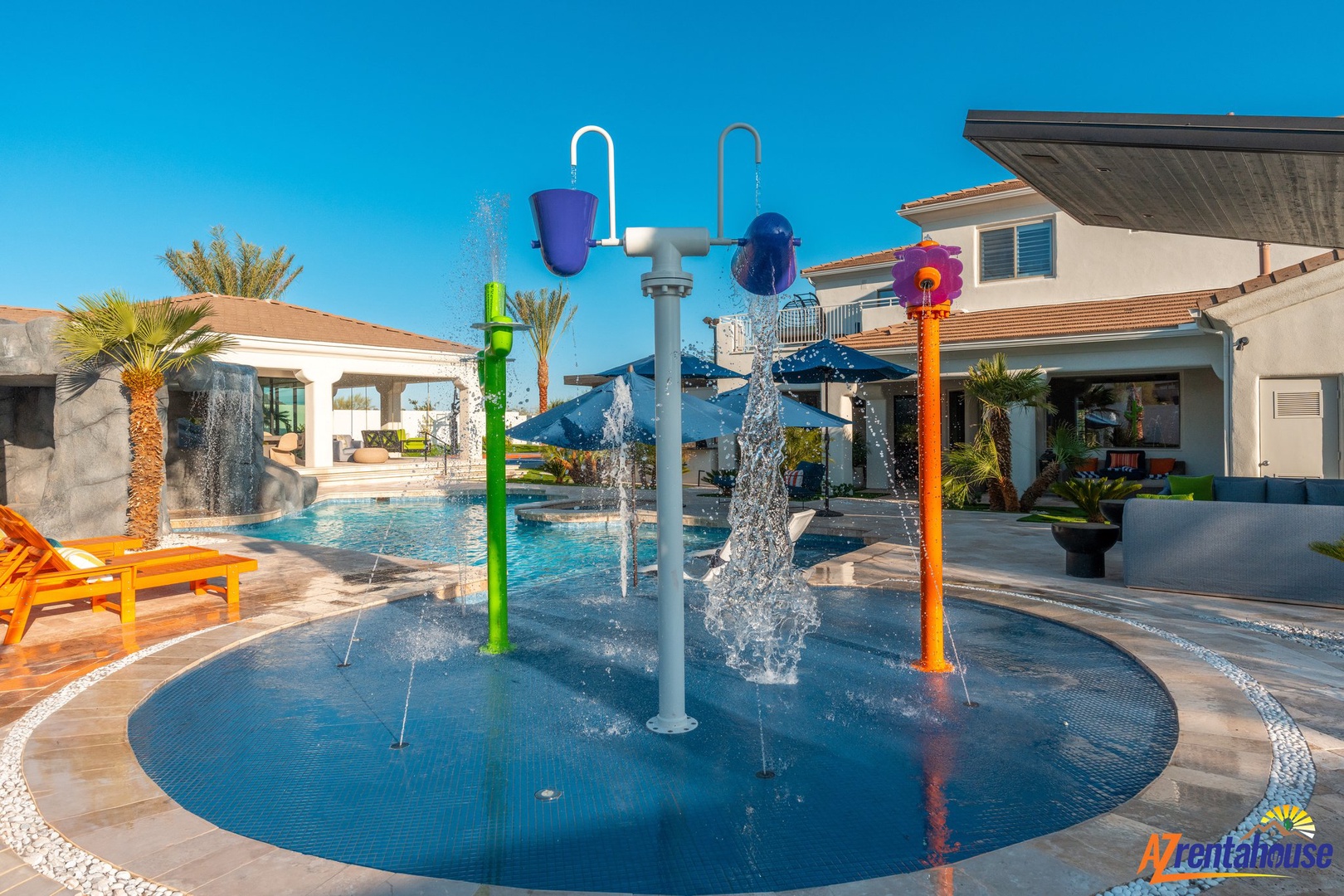 Watch the kids splash and giggle in this colorful water playground, while you relax poolside under the warm sun.