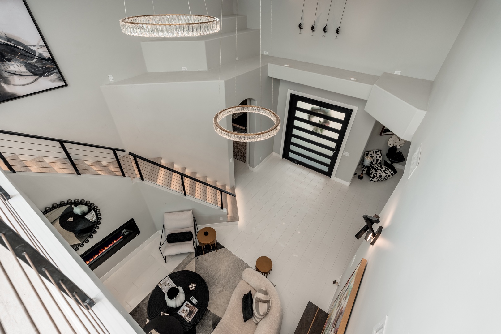 From above, you'll take in the soaring ceilings and stunning chandelier lighting that defines your space. Contemporary design meets comfort with multiple seating areas, a cozy fireplace, and elegant finishes throughout.