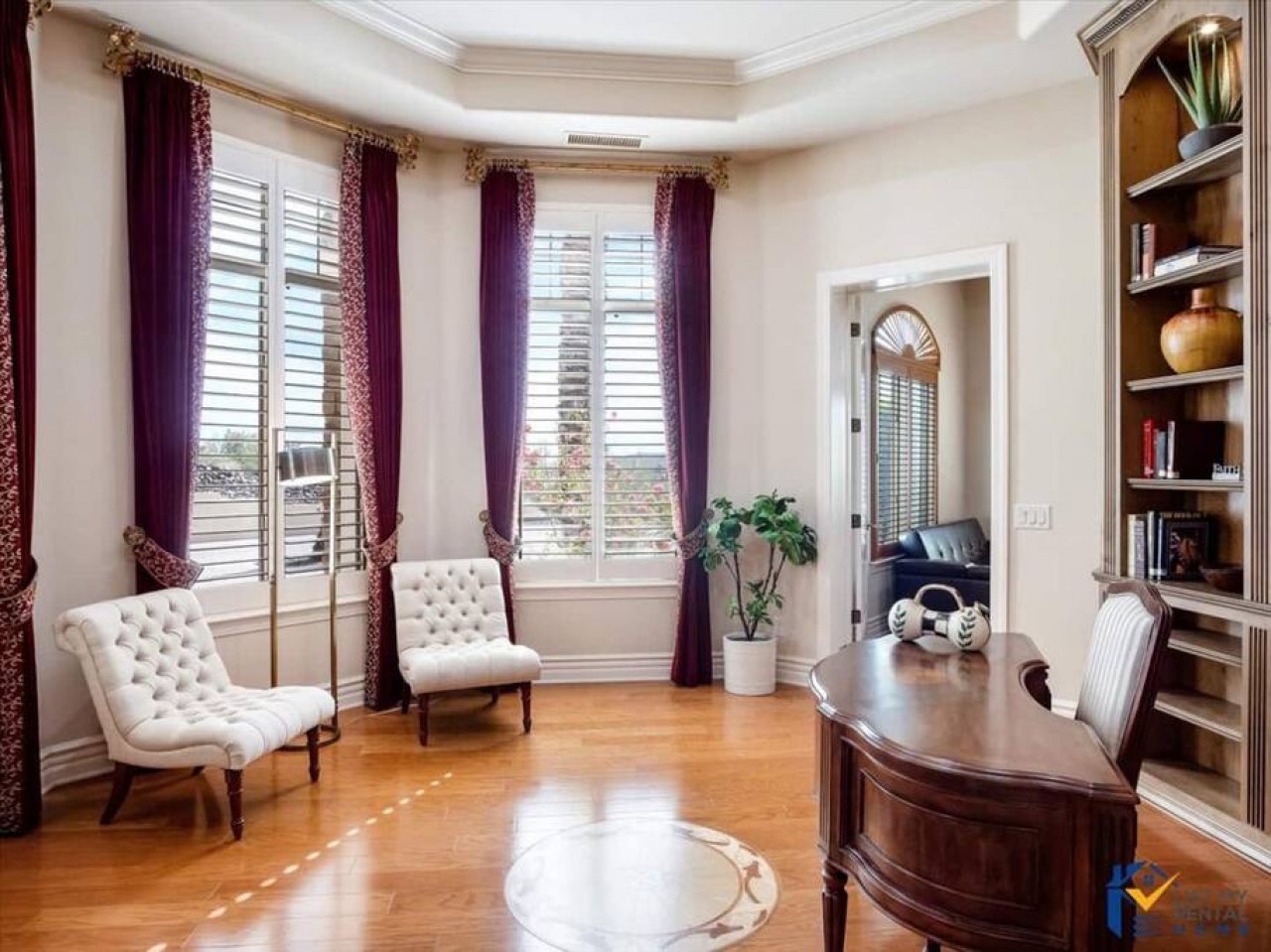 Settle into your elegant workspace, where rich purple drapes and plush tufted chairs create the perfect atmosphere for productive mornings.