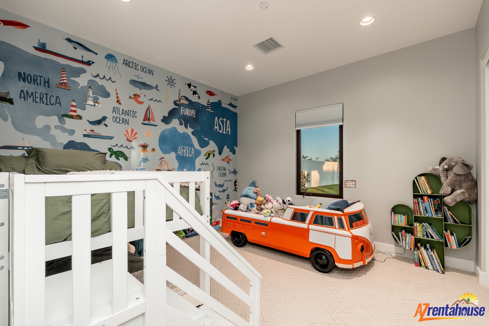 Your little explorers will love this adventure-themed bedroom with world map walls, bunk beds, and creative play spaces.
