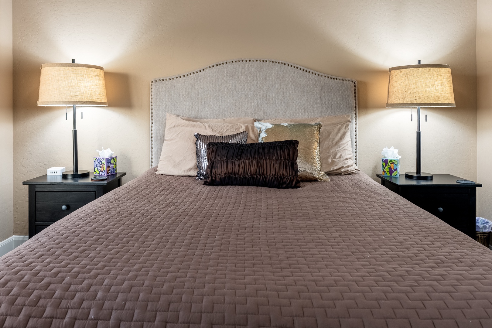 Sink into your plush bed with its elegant upholstered headboard, flanked by stylish nightstands and soft ambient lighting. A peaceful retreat awaits your arrival.