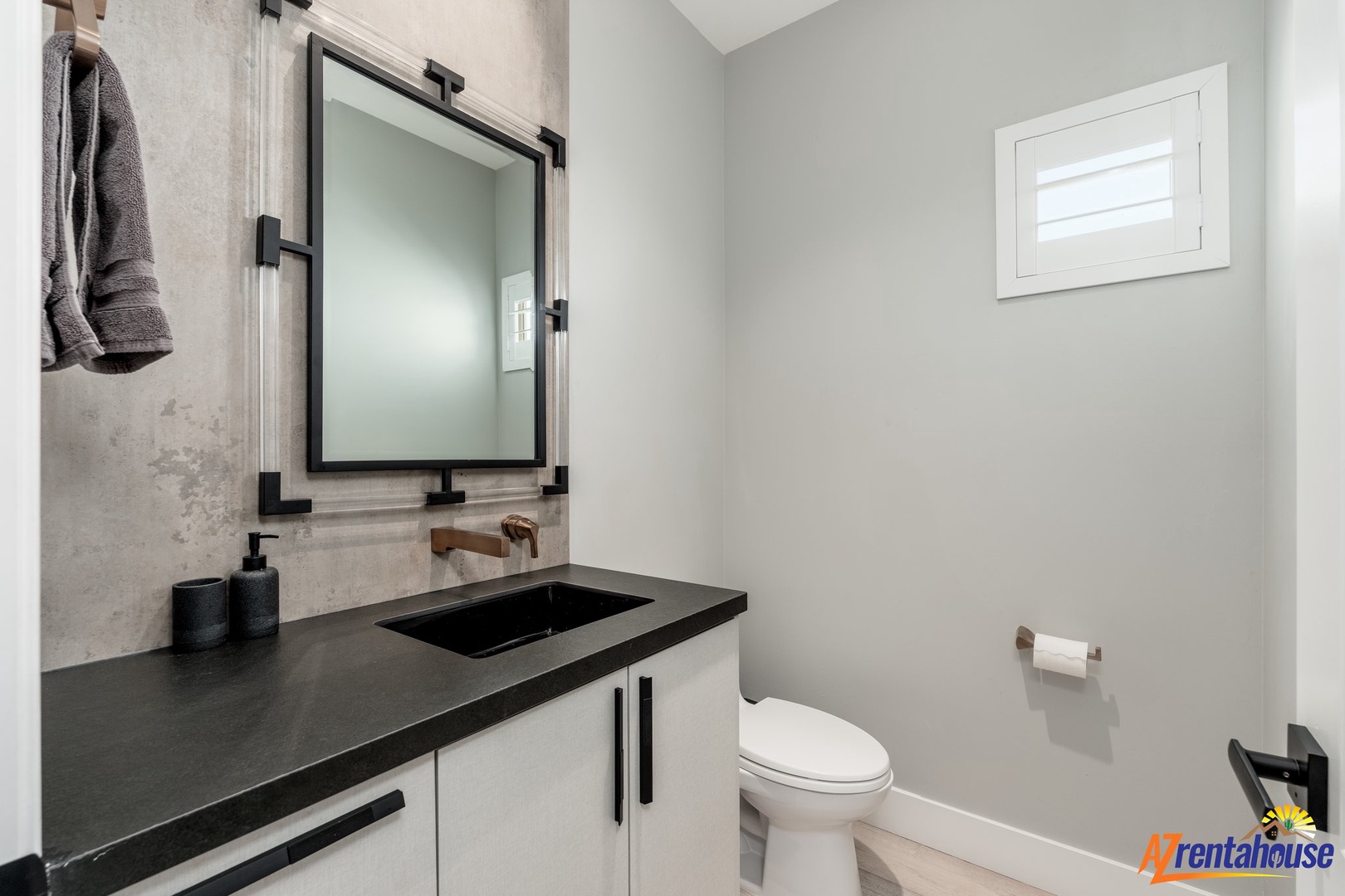 Fresh towels await in your sleek powder room with modern finishes and natural light.