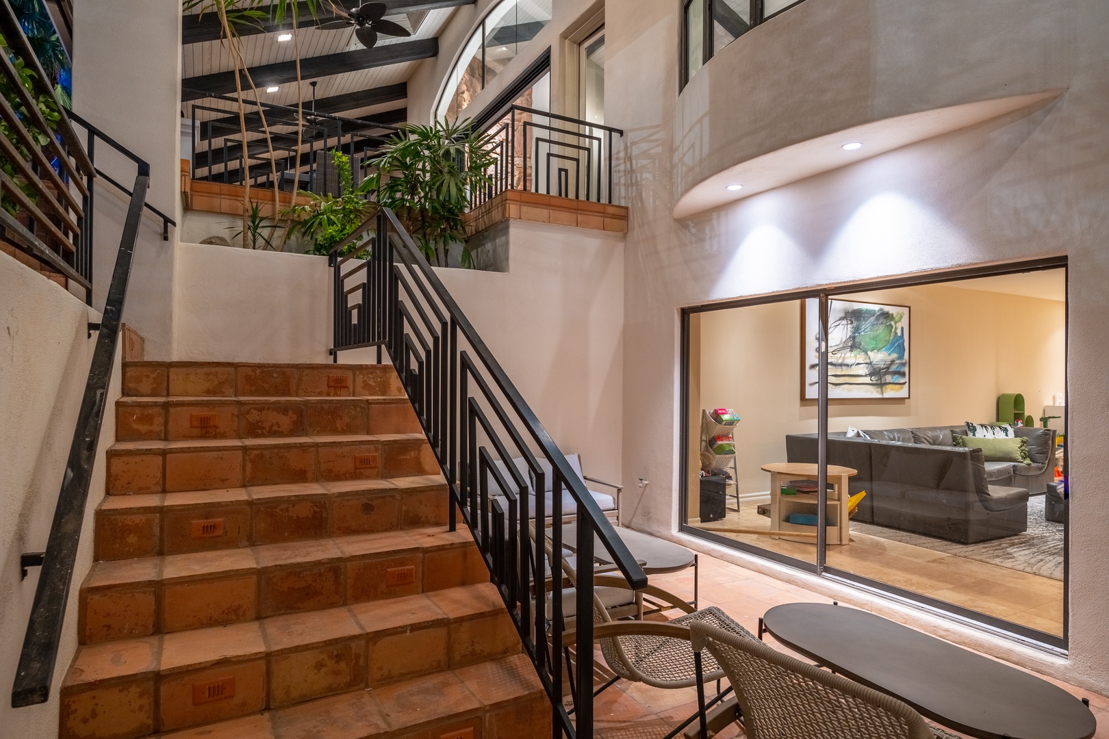 Step into your spacious retreat where modern elegance meets tropical charm. Terracotta stairs lead you through open-air atriums with lush greenery, connecting living spaces flooded with natural light.