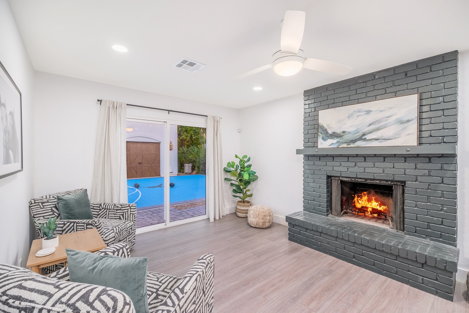 Unwind in this bright, modern living room where a cozy fireplace and plush seating invite you to relax after a day of exploring or swimming.