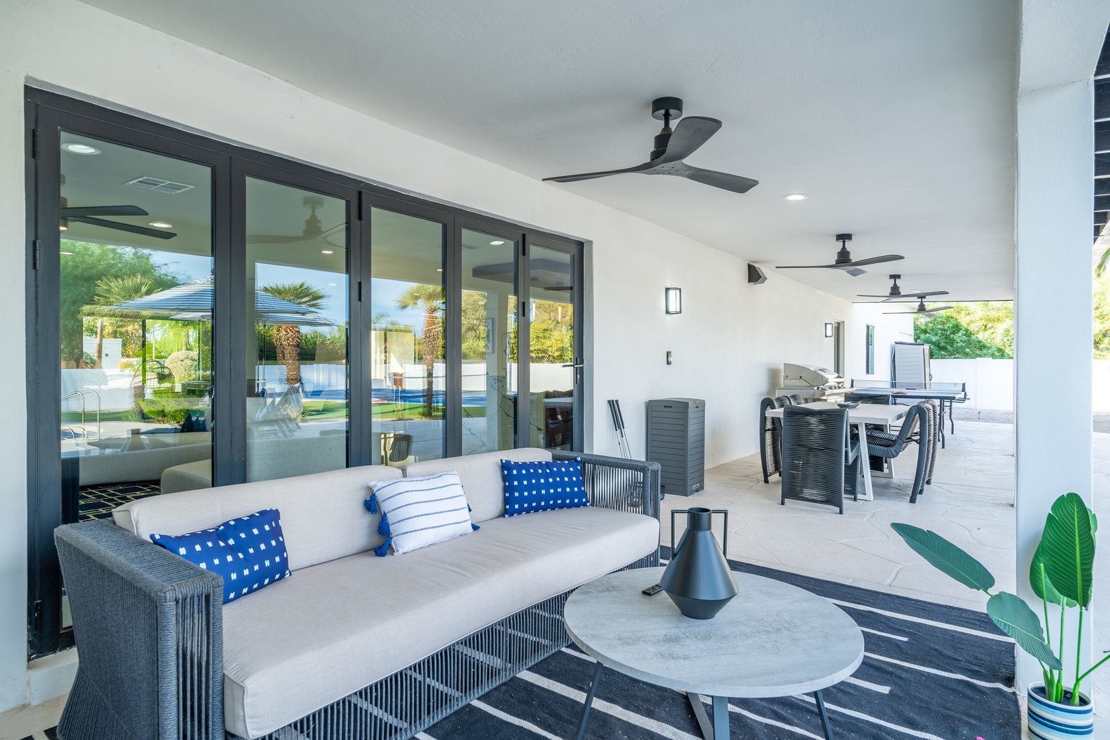 Unwind in your covered outdoor lounge, where plush seating, ceiling fans, and seamless indoor-outdoor flow invite you to relax in comfort and style.
