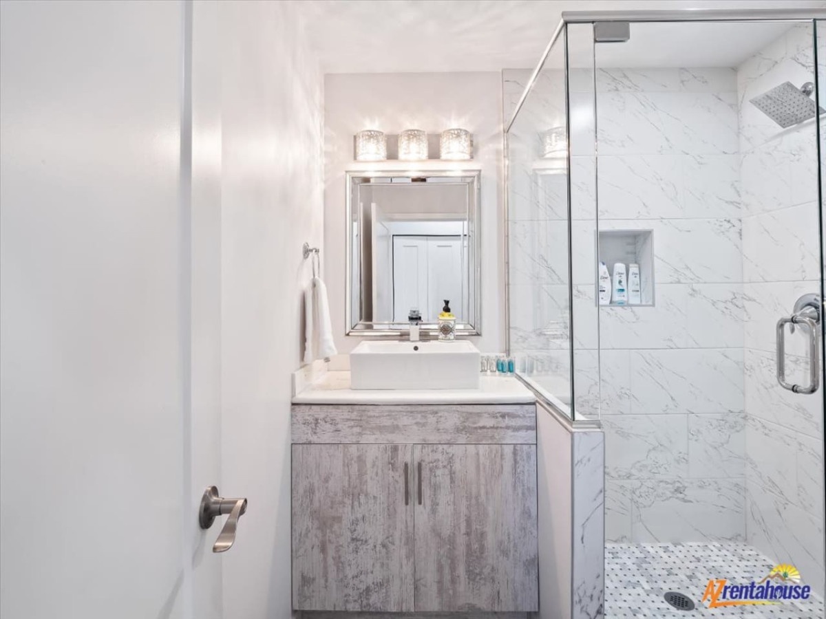 Indulge in your private spa-like bathroom with rainfall shower, elegant marble finishes, and luxury amenities waiting for your relaxation.