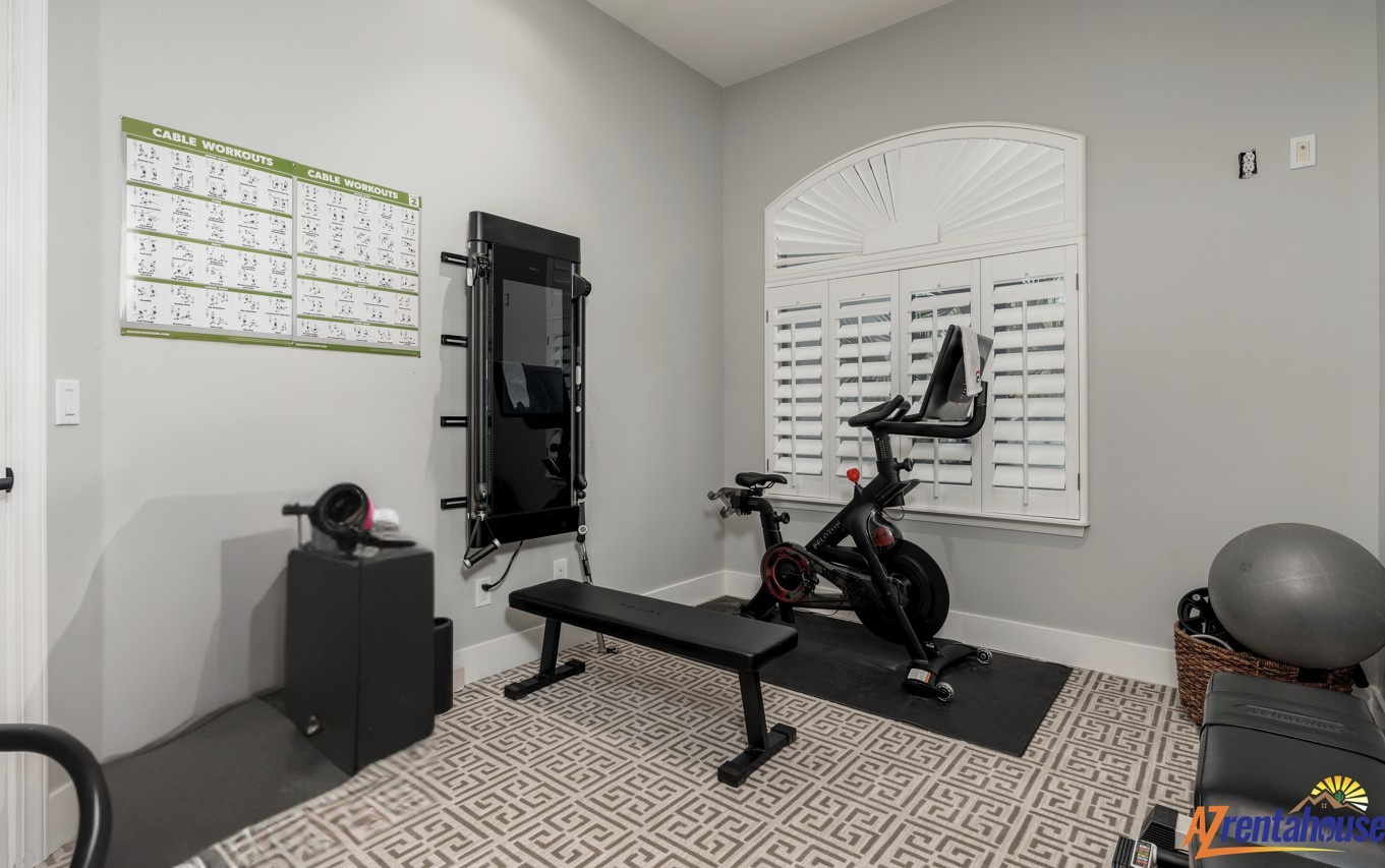 Your private fitness sanctuary awaits with premium equipment and natural light streaming through plantation shutters for energizing workouts.