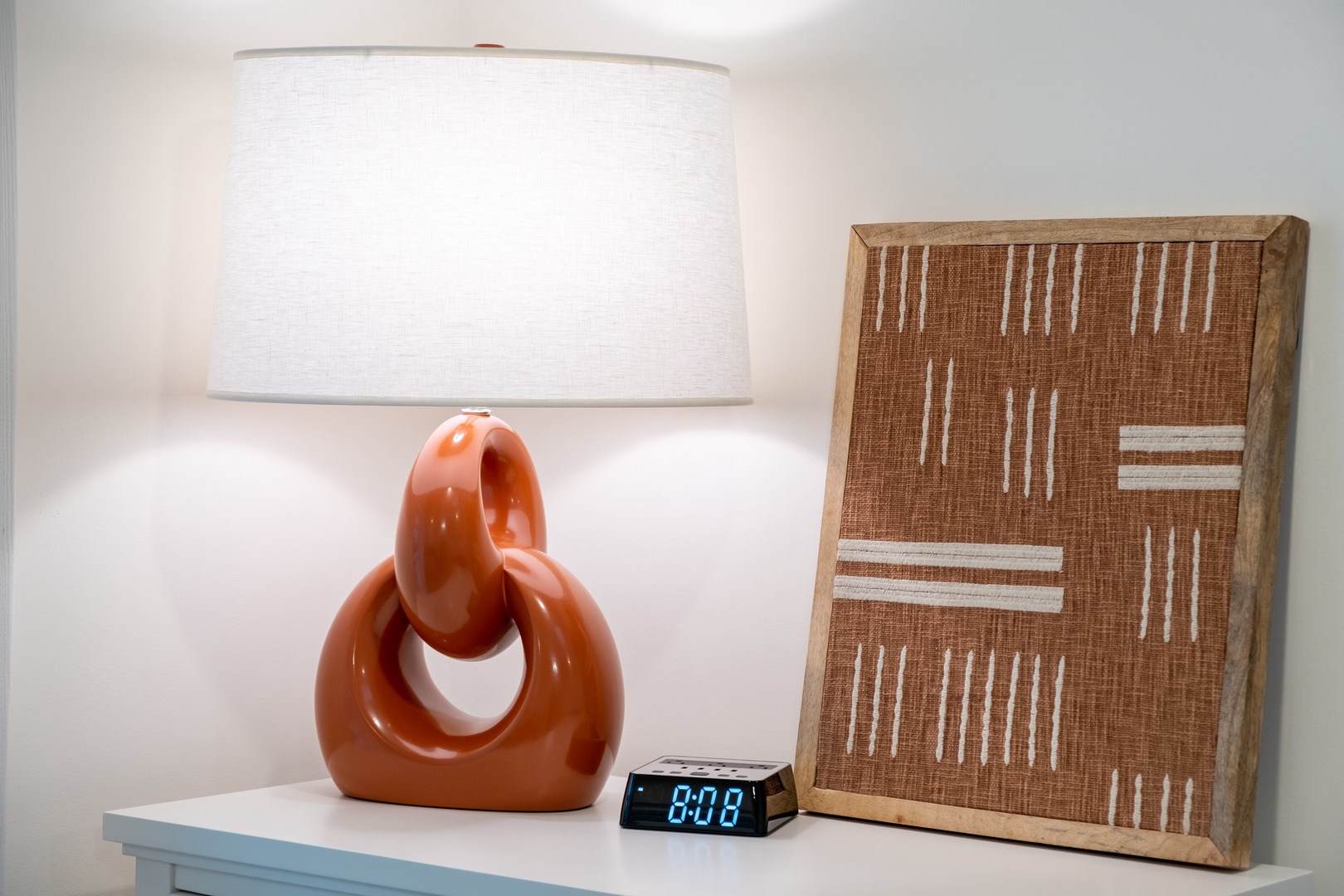 Stylish bedside details await, with a sculptural lamp and artisan décor creating a soothing space where you can unwind and drift off to peaceful dreams.