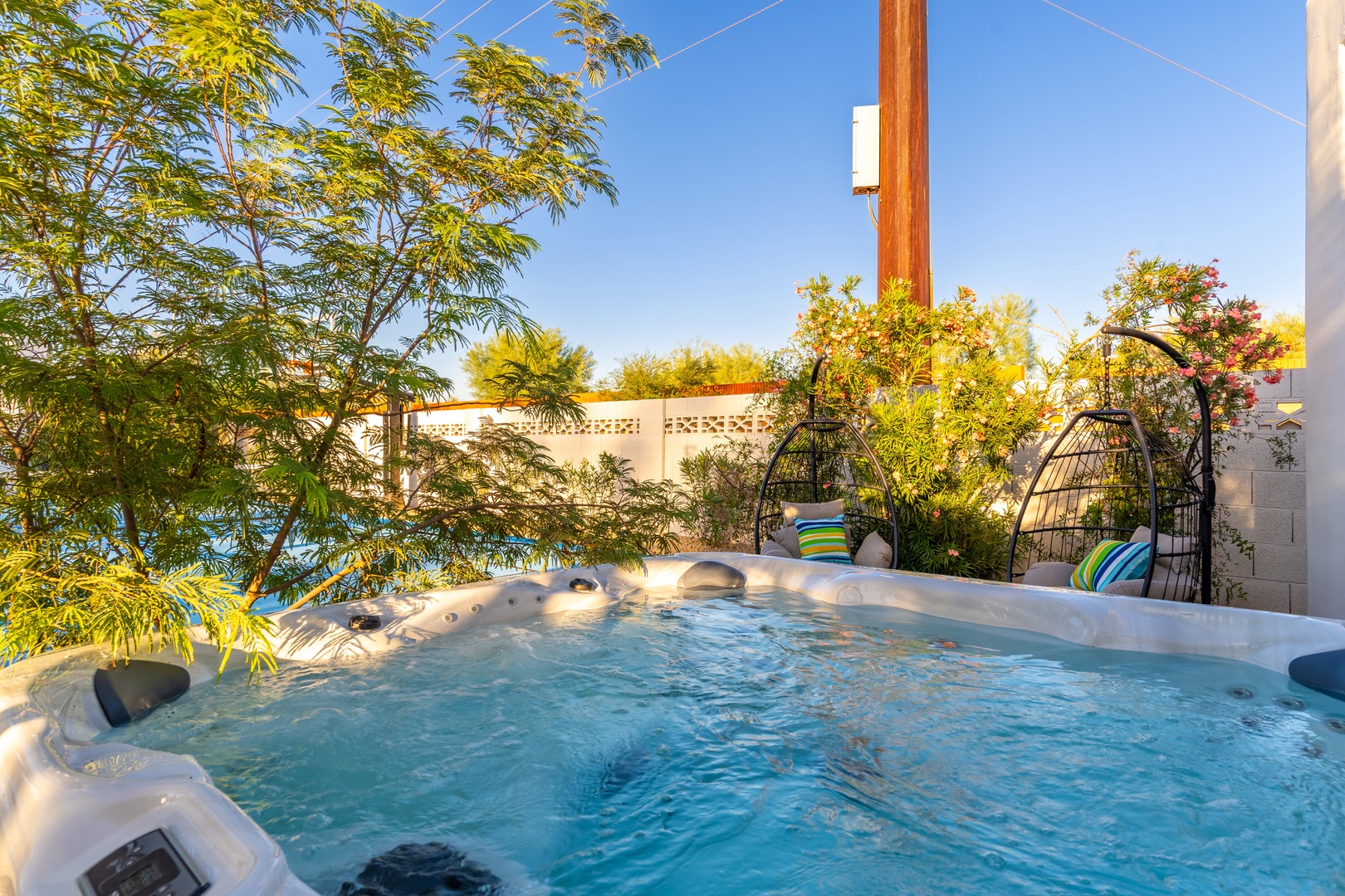 Slip into the bubbling hot tub and let your cares melt away. Soak in the warm, soothing jets while surrounded by lush greenery and vibrant desert skies—pure relaxation awaits.