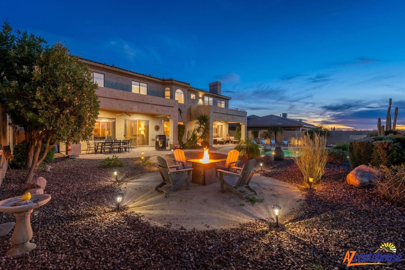 Stunning desert luxury home with fire pit and mountain views, perfect for evening gatherings under Arizona's spectacular skies.