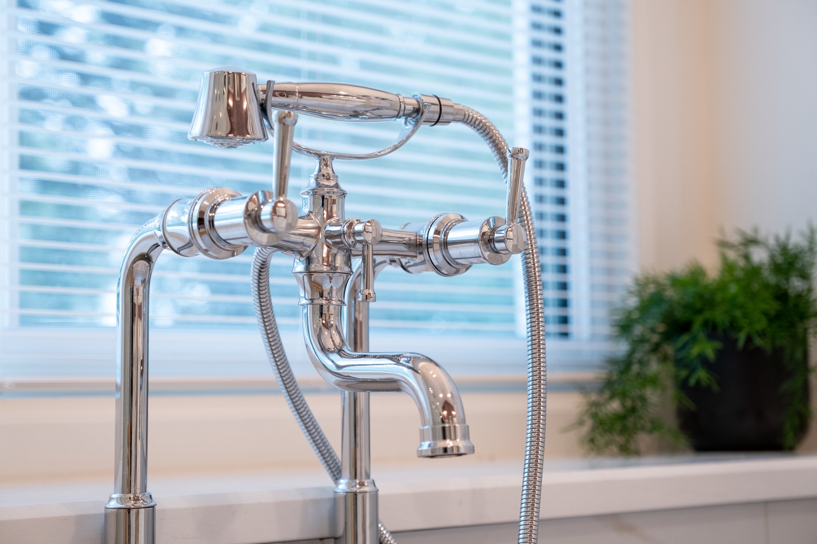 Elegant chrome fixtures catch the light in this refreshingly bright bathroom, offering a blend of classic style and modern convenience for your stay.
