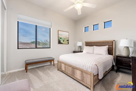 Your peaceful bedroom features a comfortable queen bed and natural light from multiple windows, creating a serene retreat for restful nights.