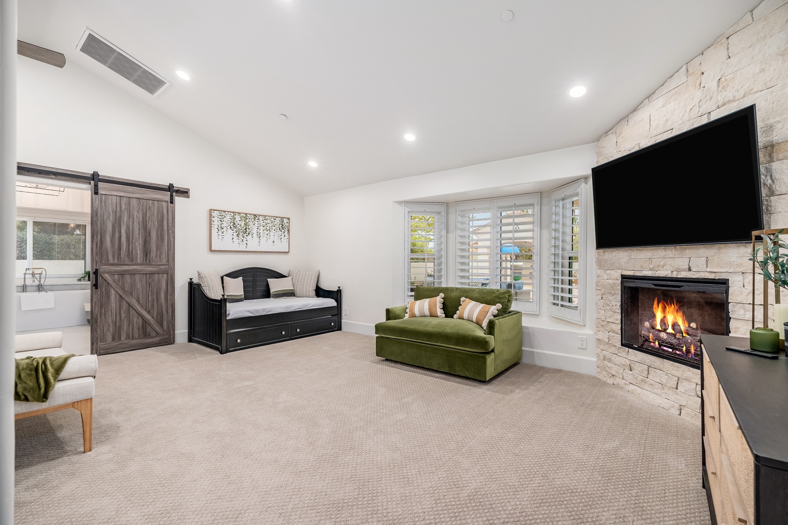 Settle into this bright, spacious bedroom where plush seating invites you to unwind by the cozy fireplace, while the daybed offers extra sleeping space for your group.