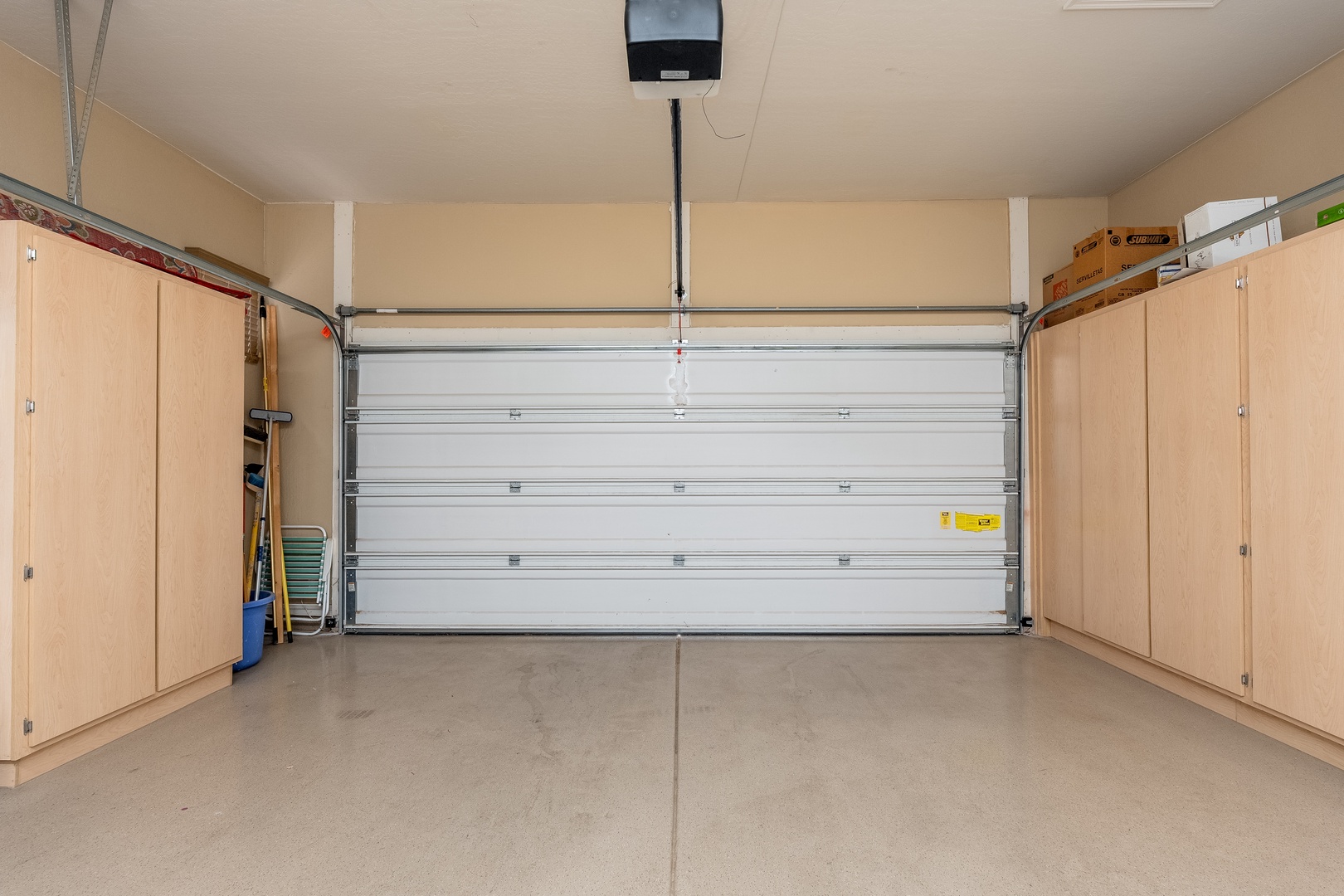 A spacious two-car garage with ample built-in storage cabinets offers secure, convenient parking for your vehicles and belongings.