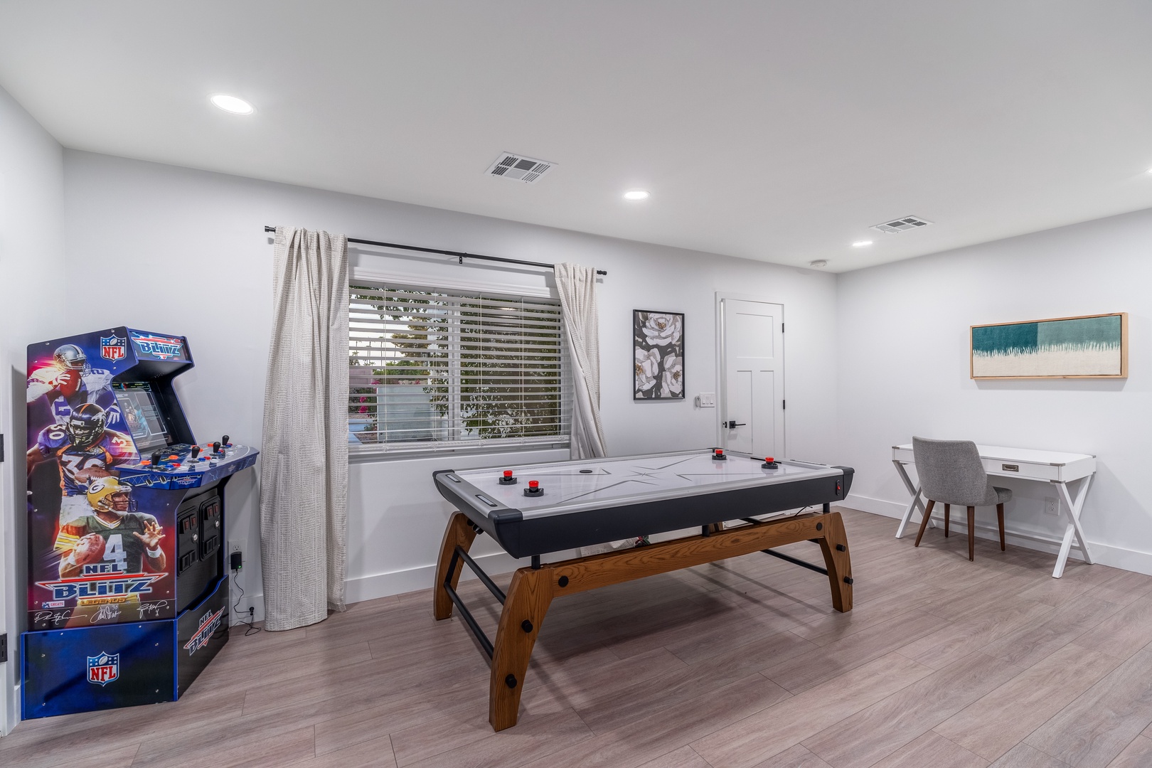 Your private game room is ready for friendly competition with air hockey, arcade games, and a work desk to balance fun and productivity during your stay.