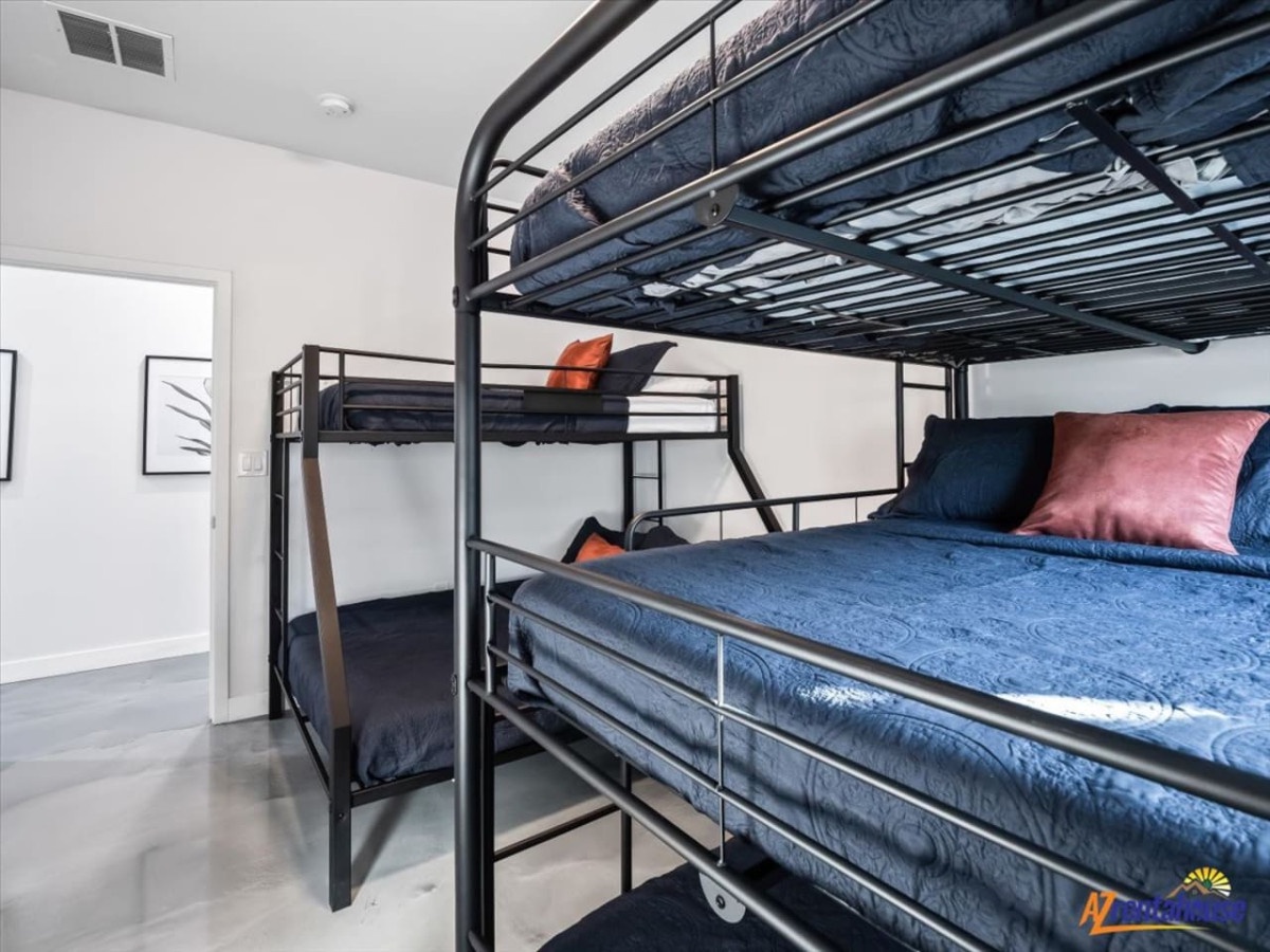 Your modern bunk room sleeps everyone comfortably, with cozy navy bedding and colorful accent pillows perfect for groups or families.