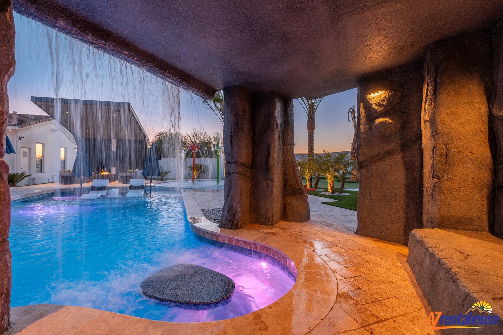Relax in your private hot tub while enjoying cascading waterfalls and stunning twilight views in this luxurious cave-like retreat.