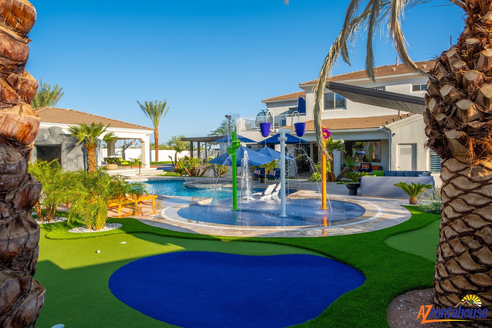 Family paradise awaits with a splash pad, swimming pool, and tropical landscaping creating the perfect outdoor playground.