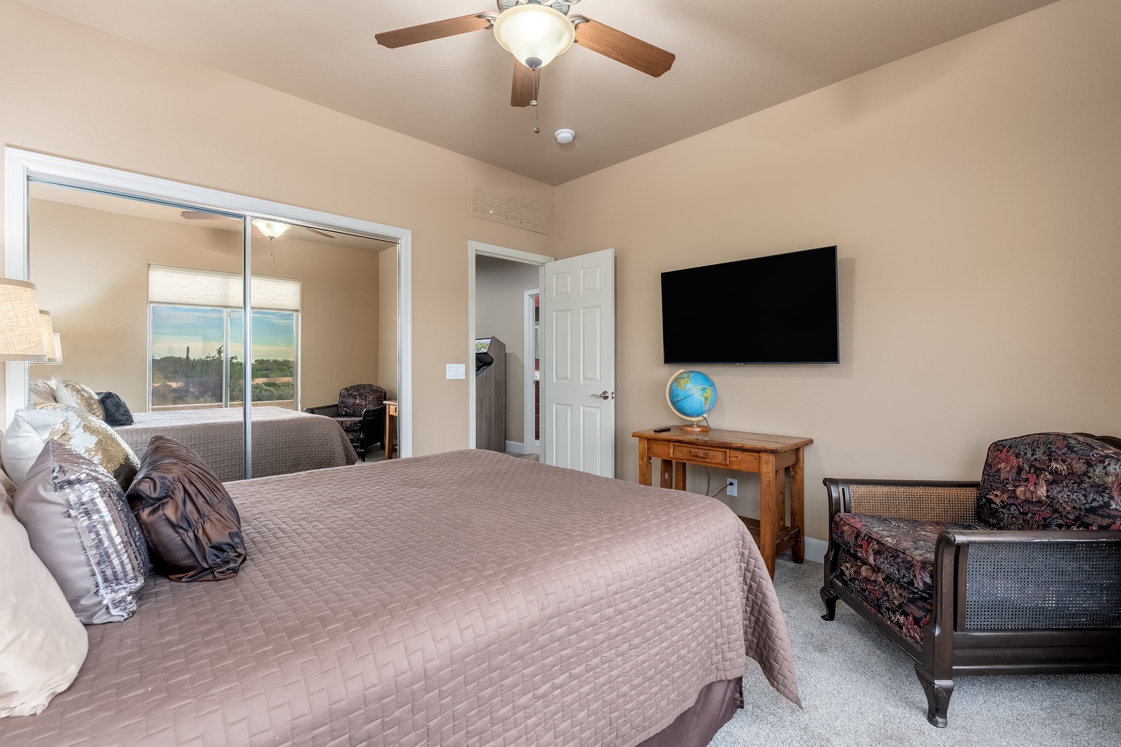 Settle into your serene bedroom where a plush queen bed, ceiling fan, and wall-mounted TV create your perfect retreat. Enjoy desert views through your private ensuite and unwind in comfort.