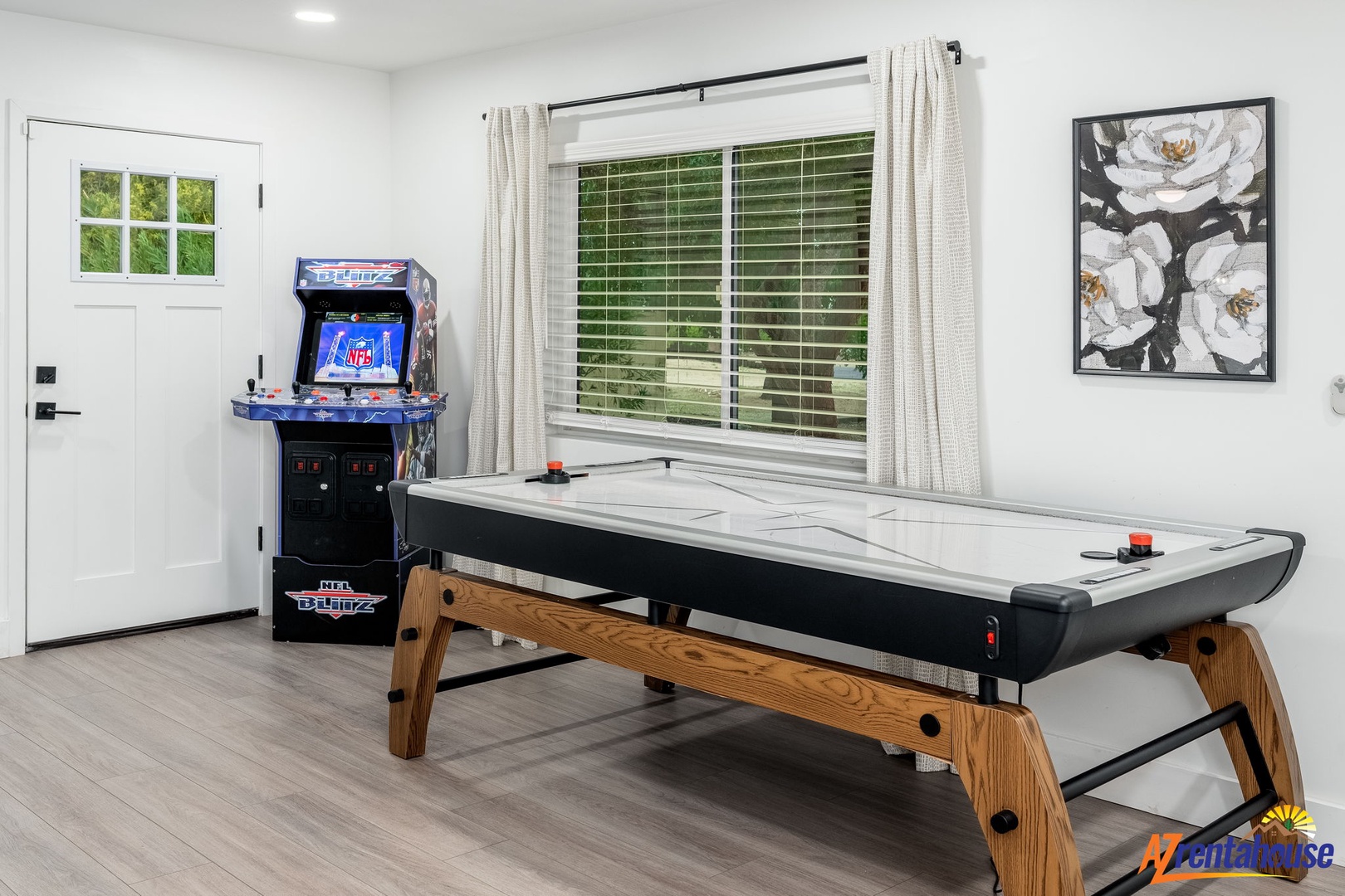 Challenge friends to air hockey battles in this bright game room featuring arcade fun and sleek modern furnishings.