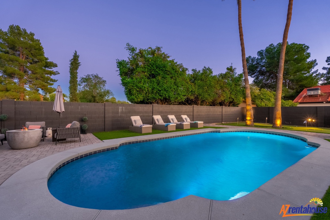 Private backyard oasis featuring sparkling pool, lounge chairs, and twilight ambiance for memorable evenings.