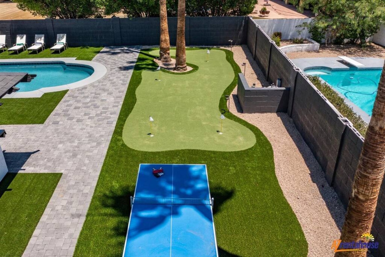 Private putting green and ping pong table create your perfect backyard entertainment zone alongside sparkling pools.