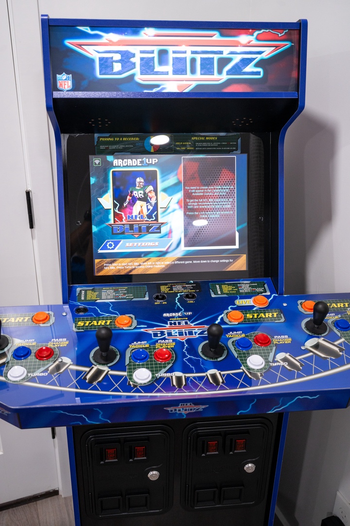 Get your game on with this NFL Blitz arcade machine, bringing classic football action to your rental with its bright screen, authentic controls, and nostalgic fun for players of all ages.