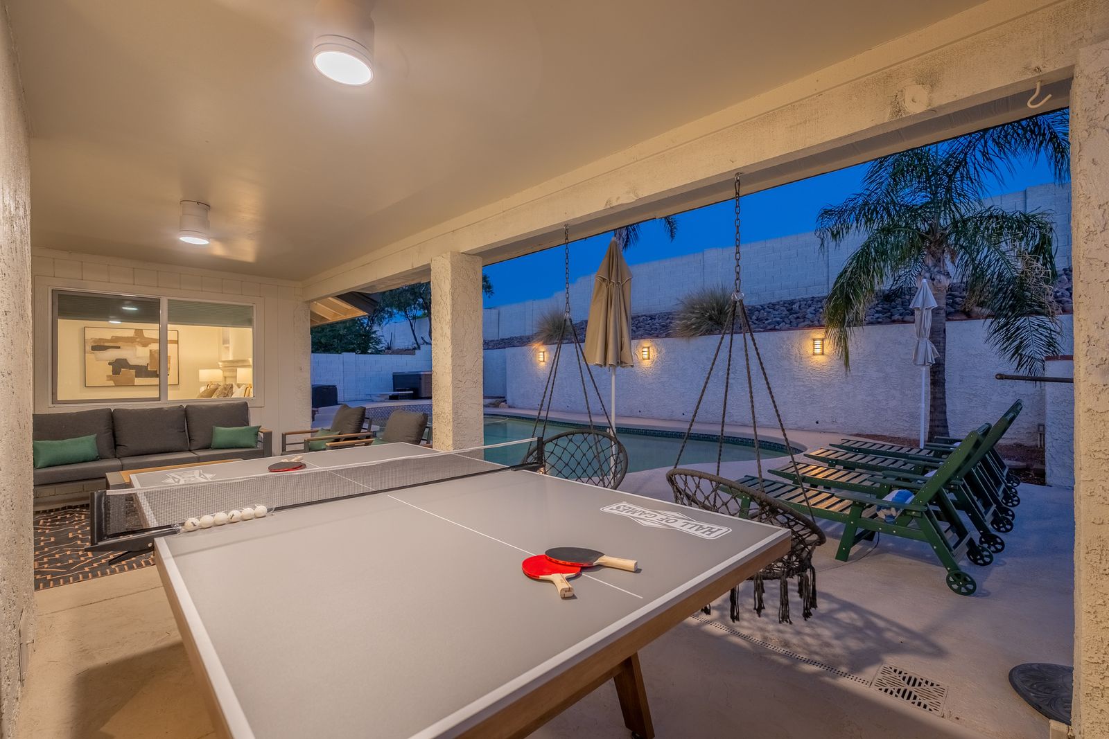 Your evenings here blend relaxation and fun: unwind with ping pong under warm lighting, lounge in hanging chairs, or take a refreshing dip in the pool as palm trees sway overhead.