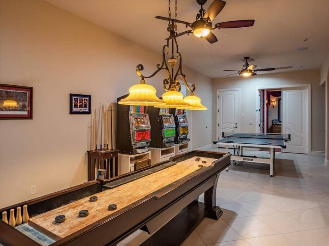 Your private game room awaits with shuffleboard, air hockey, and vintage slot machines—perfect for friendly competition and endless fun with loved ones.