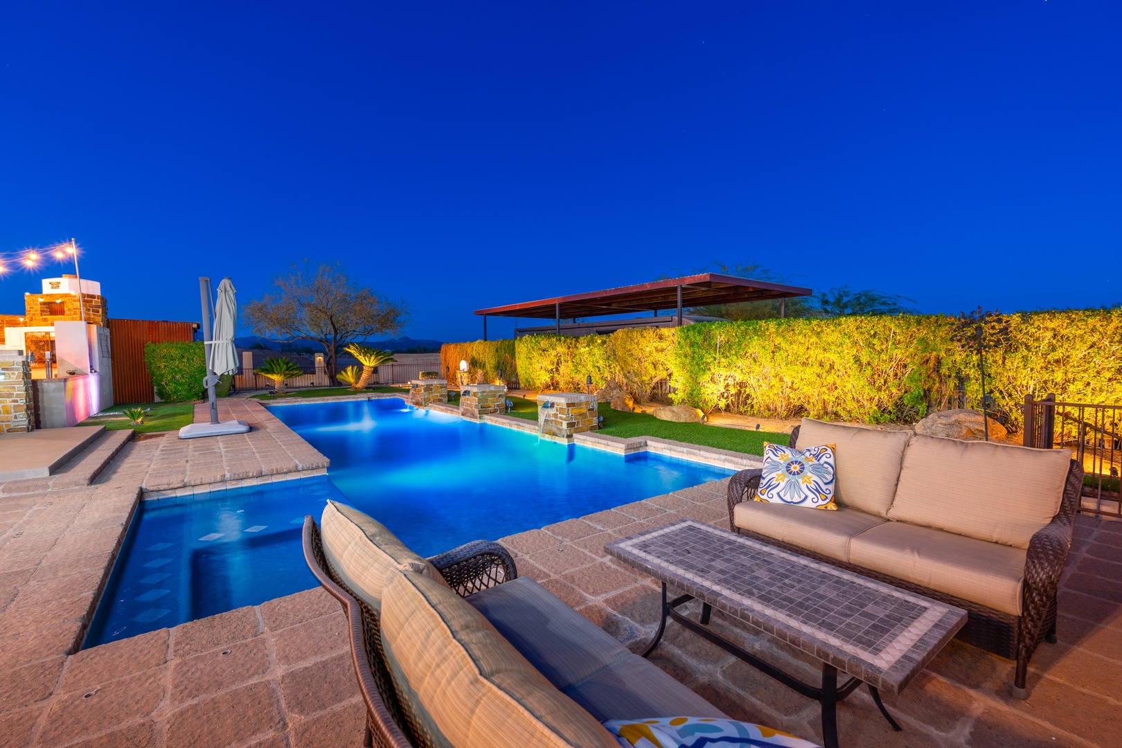 Unwind by your private pool as evening lights dance across the water, with plush lounge seating and lush gardens creating your perfect outdoor retreat.