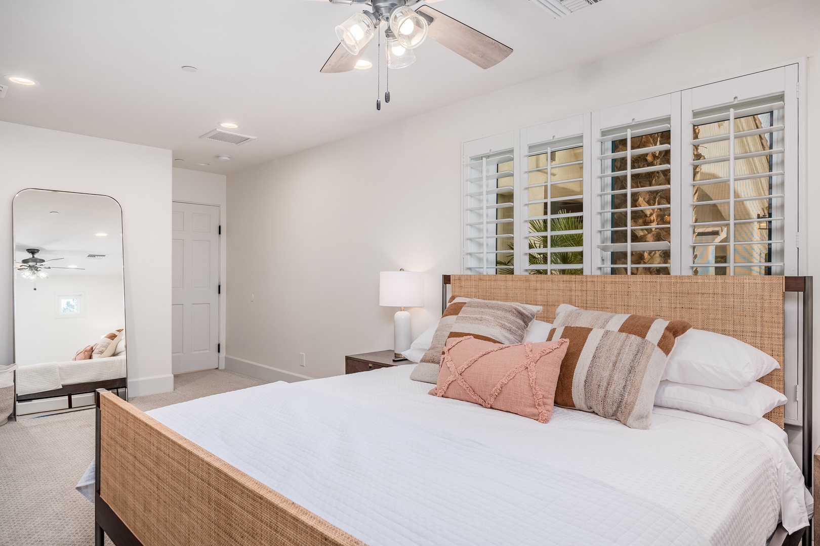 Unwind in your serene bedroom, where soft linens and calming coastal tones invite restful nights. Natural light filters through plantation shutters, creating a peaceful retreat for your stay.