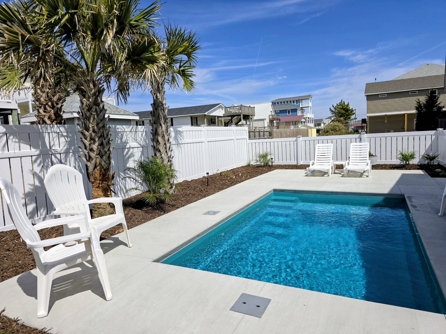 Dive into your private oasis with crystal-clear pool waters, tropical palms, and comfortable poolside loungers for perfect sunny days.