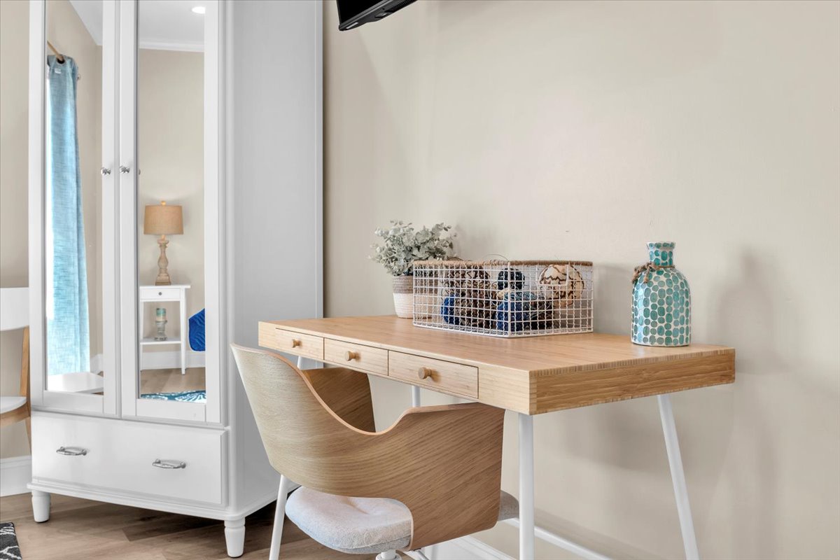 Your stylish workspace features a sleek wooden desk and modern chair, perfect for catching up on work or planning your next adventure.