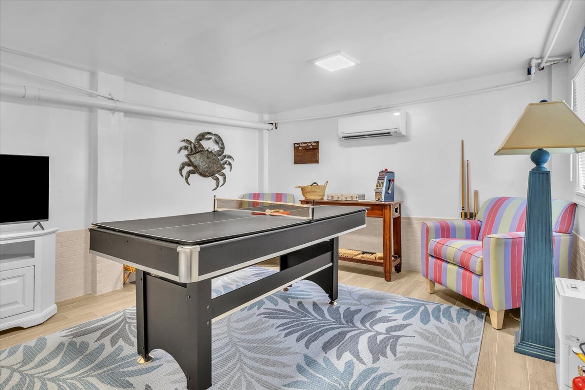 Challenge friends to pool while you unwind in this bright game room, complete with comfy seating and nautical touches.