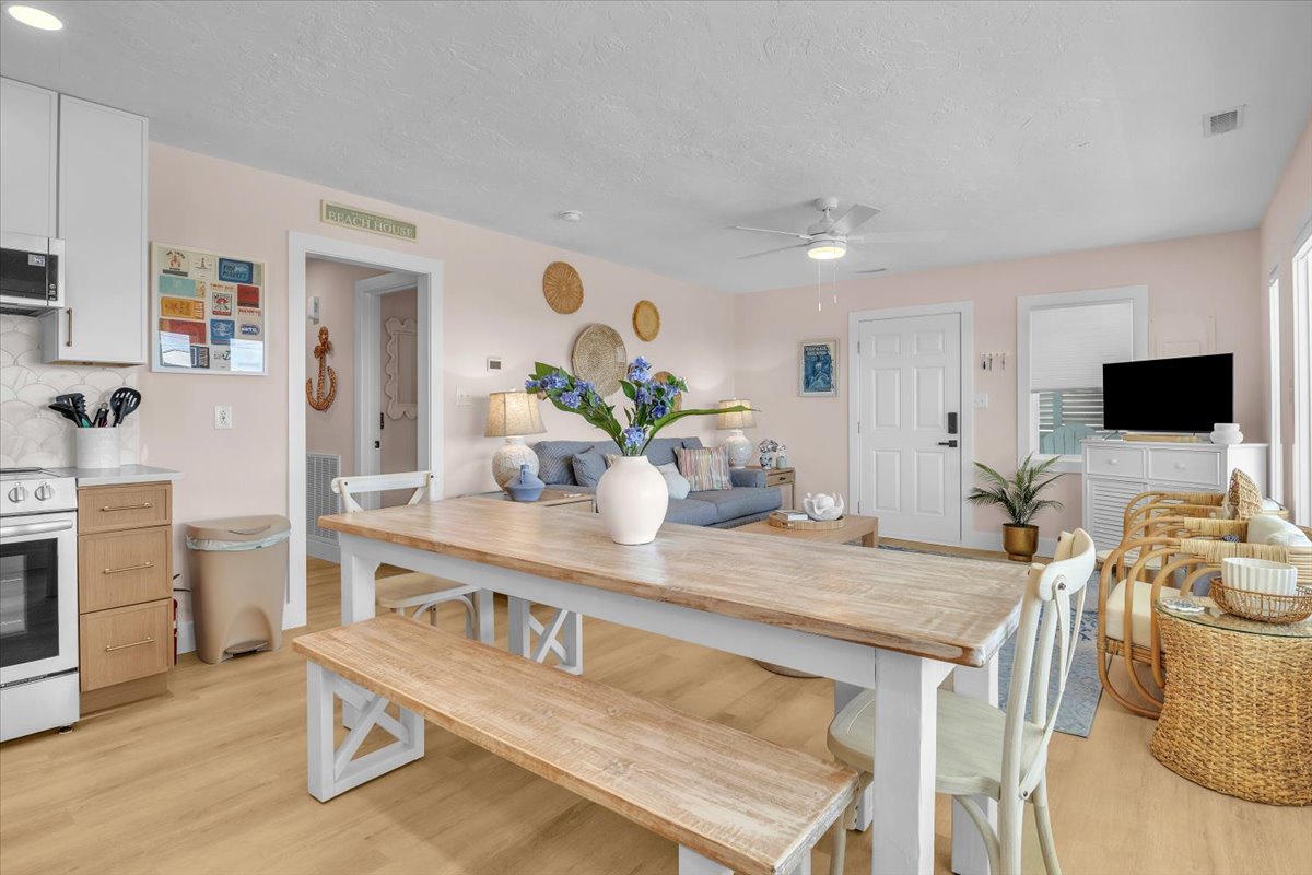 Relax in your bright, coastal-inspired open-plan living space where modern comfort meets beachy charm, perfect for gathering with loved ones.