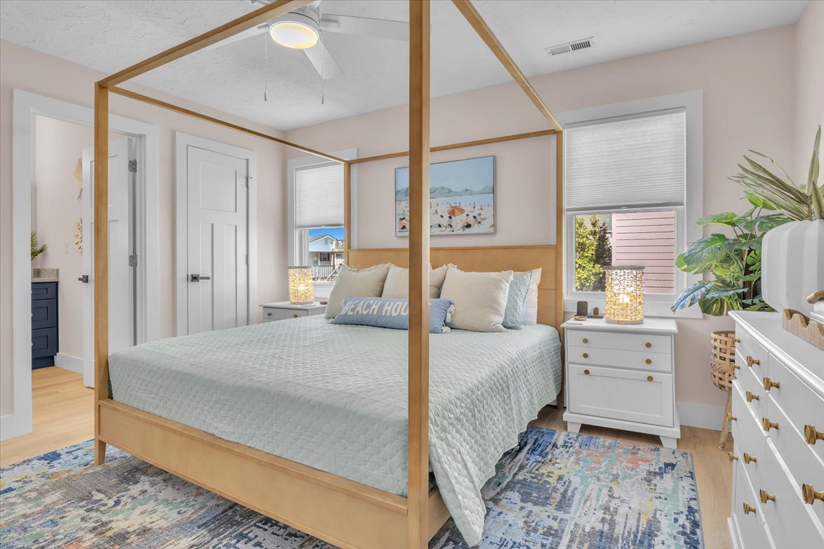 Drift off in your elegant canopy bed with coastal artwork and tropical plants creating the perfect beachside sanctuary.