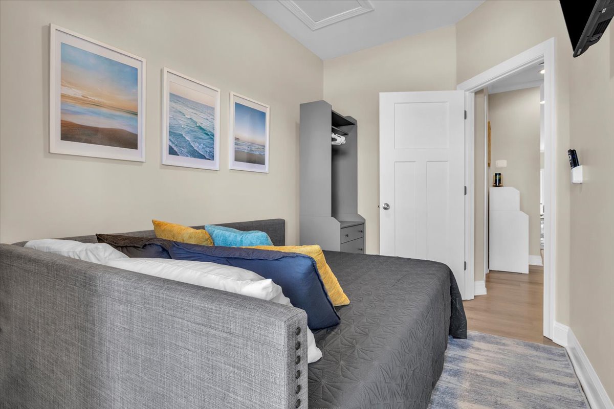 Sink into your cozy bed surrounded by soothing ocean-inspired artwork and modern amenities for the perfect restful retreat.