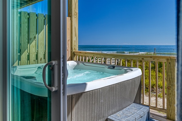 Soak in your private hot tub while watching ocean waves roll in from your beachfront balcony.