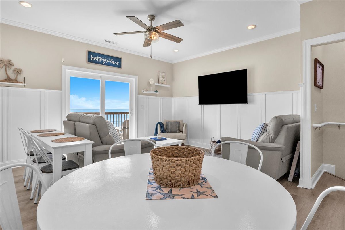 Relax in your bright living space with ocean views, comfy seating, and coastal charm for memorable beach getaway moments.